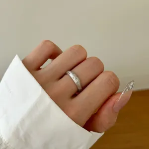 Detail of s925 silver ring featuring frosted texture and engraved star patterns