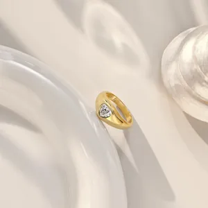 Macro shot of S925 sterling silver gold ring with heart-shaped cubic zirconia stone