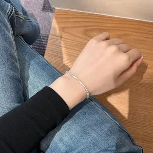 Detailed view of an S925 sterling silver tennis bracelet with cubic zirconia on a wrist