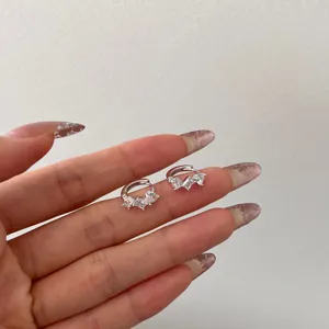 S925 sterling silver hoop earrings with three marquise cut zircon stones on a hand