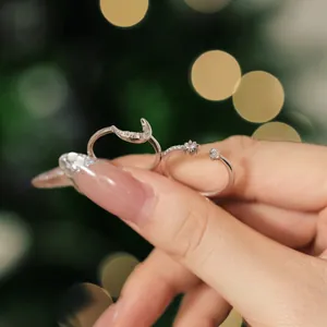 Macro shot of silver crescent moon and star rings with cubic zirconia for women