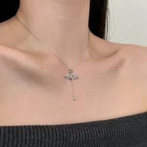 S925 silver necklace with pink heart zircon, angel wings and tassel pendant on model