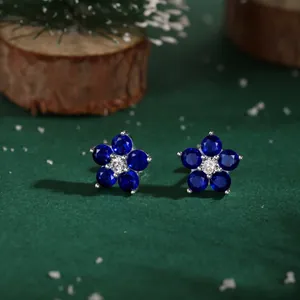 S925 silver flower stud earrings with blue crystals in a winter Christmas setting