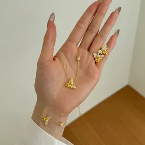 Detail of bee jewelry set with yellow zircon and pavé wings on model hands