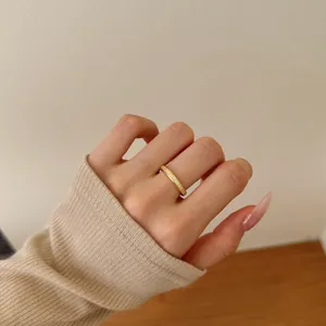 Detail of a gold-plated S925 silver ring with micro-pave cubic zirconia on a finger