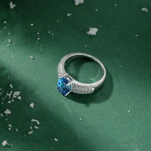 Detailed view of the large oval blue gemstone set in a sparkling silver zircon ring