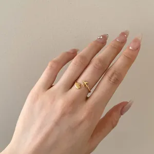 Detailed close-up of a S925 silver airplane and heart open ring on a female hand