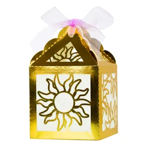 Detail of gold hollow gift box with sunburst pattern and purple organza ribbon