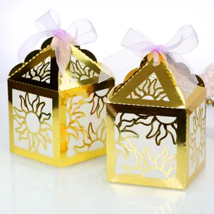 Laser-cut gold sunburst gift boxes with purple organza ribbons for wedding favors