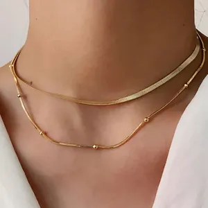 Double-layered gold necklace with minimalist snake chain and beaded strand for women