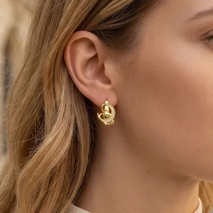 Close-up of gold moon earring with micro-pave cubic zirconia on a female ear