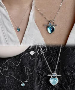 Detailed view of S925 silver OT clasp necklace with a blue heart-shaped resin pendant