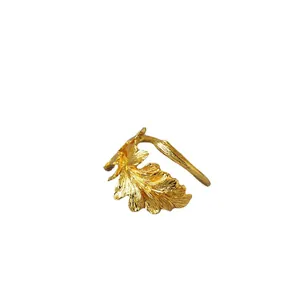 Adjustable gold plated brass ring with textured oak leaf design in minimalist style