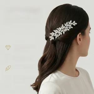 Detailed close-up of a vintage bridal hair comb with sparkly leaf-shaped rhinestones