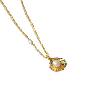 Gold shell pendant necklace with white freshwater pearl on minimalist O-link chain
