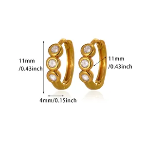 Detail view of gold hoop earrings with three inlaid clear zircons and 11mm dimensions