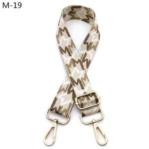 Adjustable wide woven bag strap with geometric patterns and gold metal hooks
