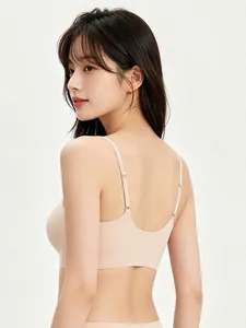 Detail of seamless skin-tone bra with adjustable thin straps and U-shaped back design