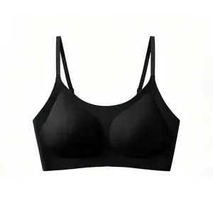 Detail view of seamless black bra with adjustable thin straps and teardrop-shaped pads