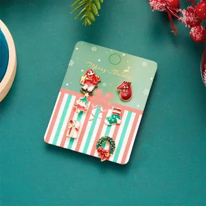 6-piece Christmas enamel brooch set featuring Santa, tree, and reindeer on a festive card