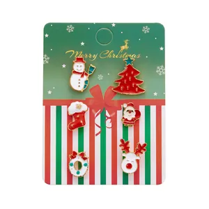 Detailed view of 6-piece Christmas enamel pins including Santa and reindeer on festive card