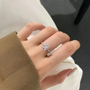 Close-up of 925 sterling silver ring with emerald cut zircon on model's hand