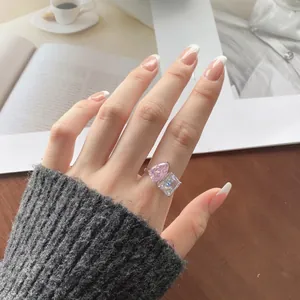 Close-up of double-stone S925 silver ring with pink pear and clear square cut cubic zirconia