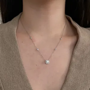 Detail of s925 silver halo pendant necklace with cubic zirconia on model neck