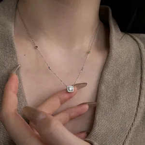 Elegant S925 silver necklace with square halo zircon pendant worn on minimalist knitwear