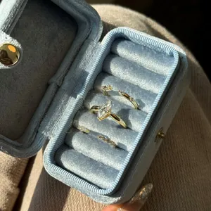Marquise-cut zircon ring set in gold on blue velvet box under natural sunlight
