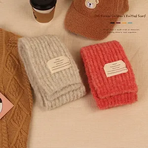 Thick knitted kids winter scarf in beige and coral orange with cozy warm texture