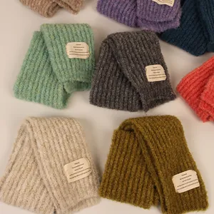 Thick knitted winter scarves with vertical ribbed texture and decorative beige patch