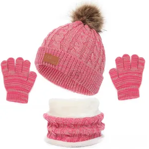 Pink winter knit set featuring a pompom hat, thick fleece neck warmer, and striped gloves