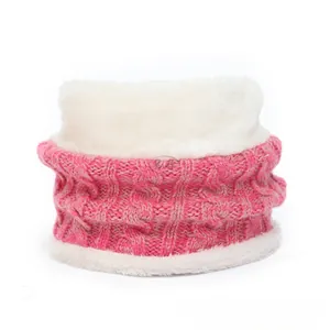Close-up of pink cable-knit infinity scarf with warm white plush fleece lining texture