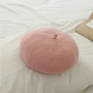 Detailed view of pink wool beret hat for girls with embroidered round logo detail