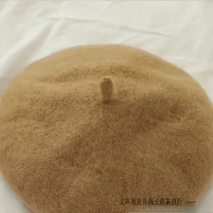Close-up of camel wool felt beret showing thick fiber texture and classic French style