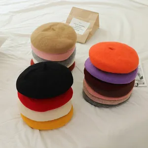 Macro detail of various colors of wool blend beret hats for girls in a cozy setup