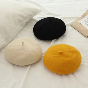 Classic kids wool beret hats in black, beige and yellow colors with soft texture