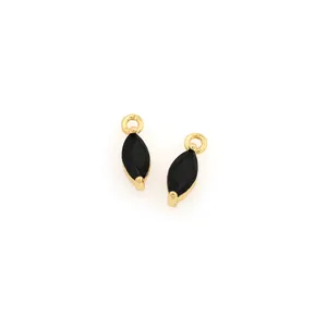 Macro view of two marquise-cut black gems in gold-plated drop pendant settings