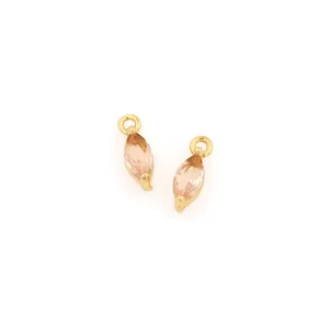 Macro view of marquise-cut champagne gems with 18K gold-plated settings for DIY jewelry