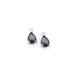 Detailed close-up of pair of pear-cut purple zircon pendants in 18K gold-plated setting