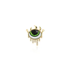 Detailed view of 18K gold-plated evil eye pendant with green enamel and white zircon fringes