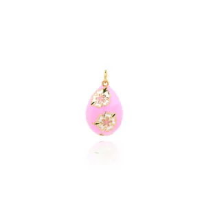 Macro view of pink enamel flower pendant with 18K gold plating and zircon inlay details