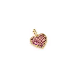 Detailed macro view of 18K gold heart pendant with pink stones and tiny zircons