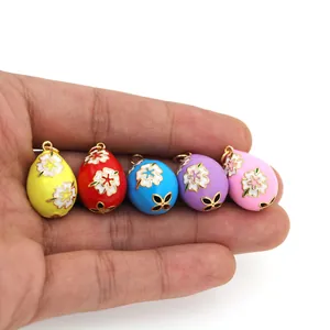 Detail of five-color enamel egg pendants with flower and butterfly patterns for DIY jewelry
