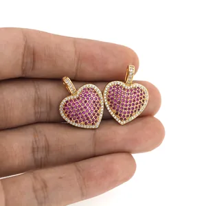 Close-up of 18K gold plated heart pendants with pink and white micro-set zircon stones