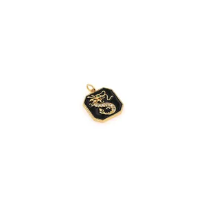 Macro detail of 18K gold-plated hexagonal dragon pendant with black enamel and zircon