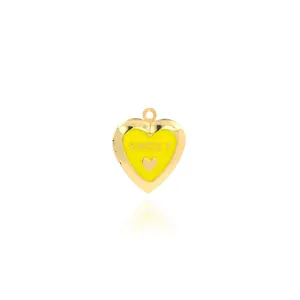 Macro detail of 18K gold-plated heart locket with yellow oil-drop and Sweet engraving