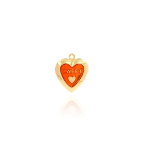 Macro detail of heart-shaped 18K gold-plated locket with red Sweet engraving