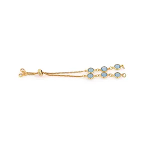 Detailed view of 18K gold-plated adjustable bracelet featuring round sky blue gemstones